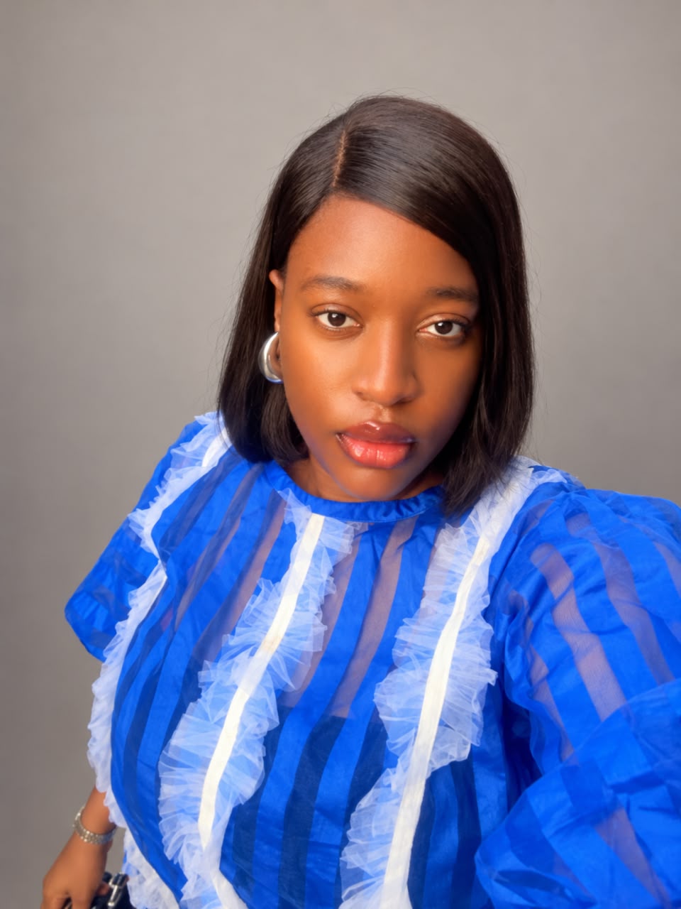Chikanma Anokwu wearing a blue and white blouse